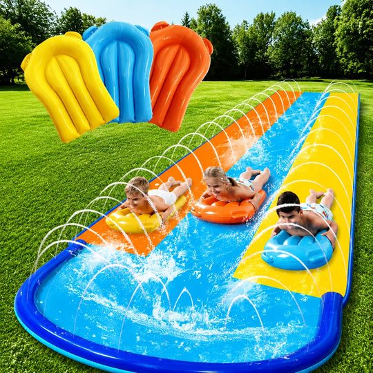 Three children using colorful bodyboards on a three-lane backyard slip and slide with surround sprinklers on grass