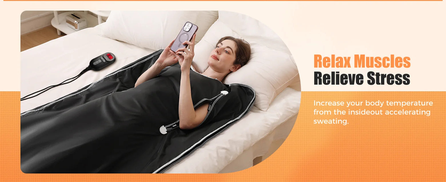Woman resting in an EHINI portable infrared sauna blanket on a bed with the wired controller nearby