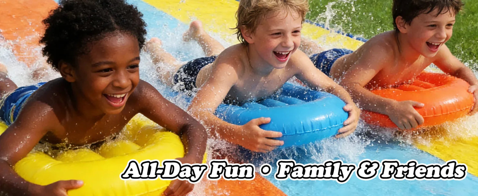 Three children racing on yellow, blue, and orange bodyboards on a colorful backyard slip and slide