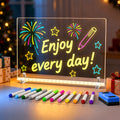 White EHINI LED drawing board for kids displaying colorful fireworks and stars with 12 fluorescent markers in a festive tabletop setting